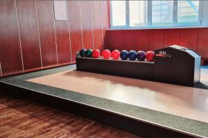 a bowling alley with a row of balls on the floor at Hotel Eger & Park in Eger