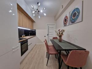 a kitchen with a dining room table and chairs at KSY Hotel Family Stay in Tbilisi City