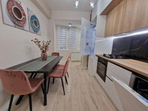 a kitchen with a table and chairs and a stove at KSY Hotel Family Stay in Tbilisi City