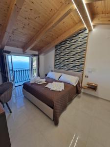 a bedroom with a large bed and a large window at Otium Relais in Furore