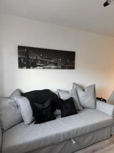 a black and white picture on the wall above a couch at Apartment Close to the Studios in Borehamwood