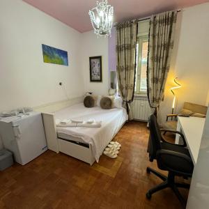 een slaapkamer met een bed, een bureau en een stoel bij Fenice in Bergamo