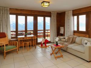 a living room with a couch and a table at Apartment Quille du diable 19 by Interhome in Nendaz