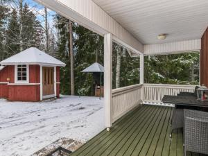 a screened porch with a gazebo in the snow at Holiday Home Mäkimökki by Interhome in Palikainen