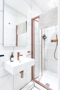a white bathroom with a sink and a shower at Stunning Boutique Flat in Central Location - Beatrice in Bath