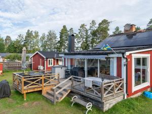 a house with a large deck and a patio at Chalet Toltorp - SDM100 by Interhome in Katrineholm