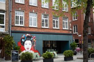 Ein Gebäude mit einem großen Wandbild einer Frau in der Unterkunft The Industria - Stylish in Historical Center in Antwerpen