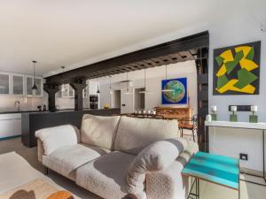 a living room with a couch and a kitchen at Apartment Cosy by Interhome in Tossa de Mar +20 photos