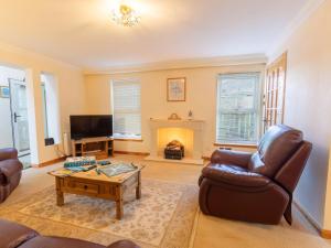 a living room with a couch and a coffee table at Holiday Home Lodge Road-1 by Interhome in Inverness