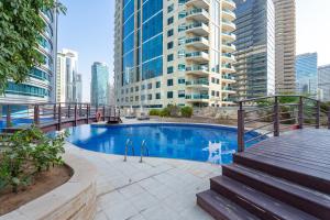a swimming pool in a city with tall buildings at Heaven Crest Holiday Homes Dubai Marina - 4 Bedroom Suite with Marina View near JBR Beach, Free Parking, Wi-Fi, Gym and Pool in Dubai