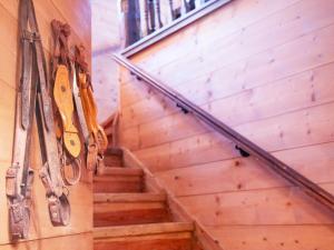 a staircase with scissors hanging on a wall at Chalet Chalet Tetras by Interhome in Chesières
