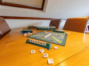 a table with a board game and dice on it at Chalet Lodge 4 by Interhome in Spean Bridge