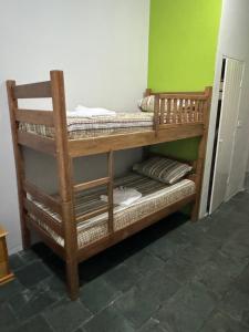a wooden bunk bed in a room at Quarto Central in Guararema