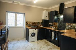 a kitchen with a washing machine in the middle at Billy's Place in Boston