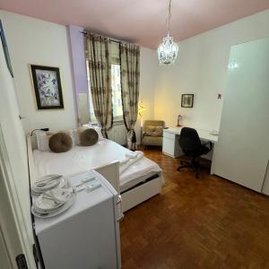 a bedroom with a bed and a desk and a chair at Fenice in Bergamo
