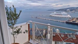 a balcony with a cruise ship in the water at Luxury room with panorama seaview in 120 m2 Apartment in Old Town of Kusadasi in Kusadası