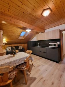 a kitchen and dining room with a table and chairs at Cesa Elena in Canazei