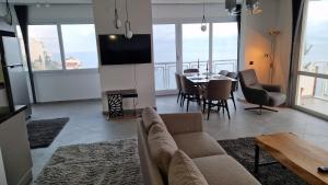 a living room with a couch and a table at Luxury room with panorama seaview in 120 m2 Apartment in Old Town of Kusadasi in Kusadası