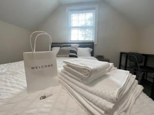 a white shopping bag sitting on top of a bed at The Castilian by Keywee Rentals in Manassas