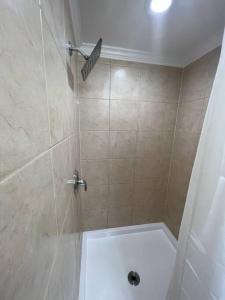 a bathroom with a shower with a glass door at The Castilian by Keywee Rentals in Manassas