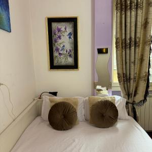 a bedroom with a bed with two pillows on it at Fenice in Bergamo