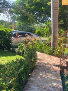 a car parked in front of a driveway at Montego Bay, Ironshore Luxury Studio in Montego Bay