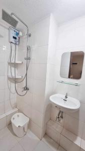 a bathroom with a shower and a toilet and a sink at 2 Br Condo Unit Cagayan de Oro City in Cagayan de Oro