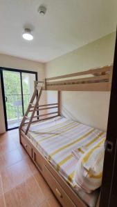 a bedroom with a bunk bed and a window at 2 Br Condo Unit Cagayan de Oro City in Cagayan de Oro