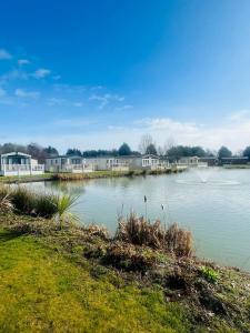 a large body of water with houses in the background at Yew Tree Lodge with Hot Tub in York