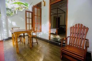 a dining room with a table and two chairs at Little Angels in Mirissa