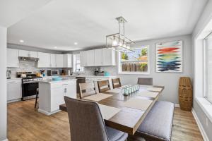 a kitchen and dining room with a table and chairs at Landmark Lakehouse - luxury living in PLX in Akron