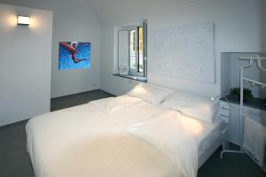 Postel nebo postele na pokoji v ubytování G30 Finalborgo Lodging'n Bike Box