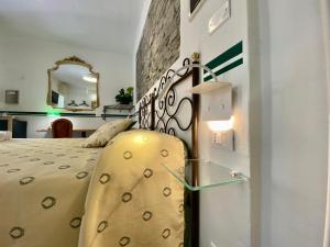 a bedroom with a large bed and a mirror at The Manarola Main Plaza in Manarola