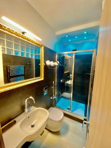 a bathroom with a sink and a toilet and a mirror at The Manarola Main Plaza in Manarola +37 photos