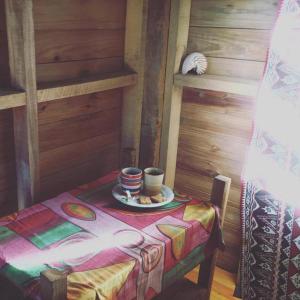 a table with a cup and a plate of food on it at Sunrise Lagoon Homestay in Nanuya Lailai