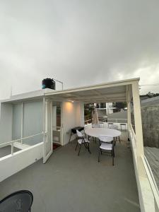 eine Terrasse mit einem Tisch und Stühlen auf dem Dach in der Unterkunft Villa Jasmine Batu in Batu