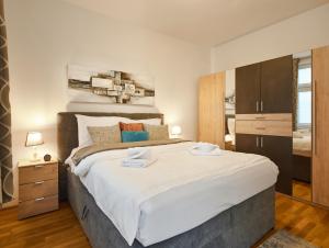 a bedroom with a large bed with white sheets at Flarent Vienna Apartments-HG in Vienna