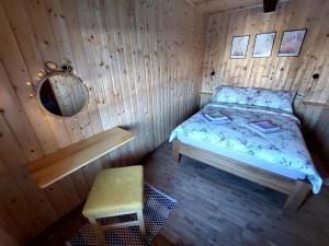 a bedroom with a bed in a wooden room at Holiday home The Hive in Slunj