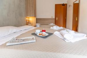Postel nebo postele na pokoji v ubytování Hotel Luana