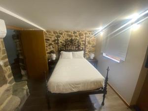 um quarto com uma cama num quarto em Casa Rosmaninho - Izei em Chaves