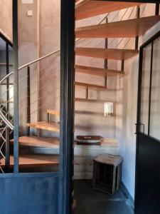 a staircase in a room with a stair case at Chalet spacieux & spa in Landry