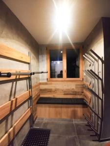 a room with wooden walls and stairs and a light at Chalet spacieux & spa in Landry