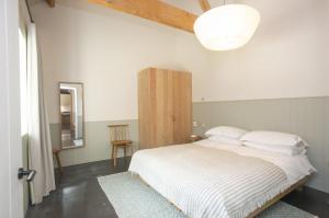 a bedroom with a white bed and a mirror at Lookout in Dorchester