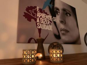 a table with a vase and two lights on it at Casa Rio, Amalia in Ferreira do Zêzere +14 photos