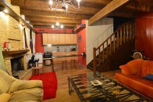 a living room with a couch and a table at Γήλοφος in Ano Trikala