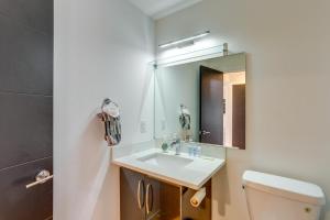 a bathroom with a sink and a mirror at Modern Tukwila Vacation Rental Near Airport! in Tukwila