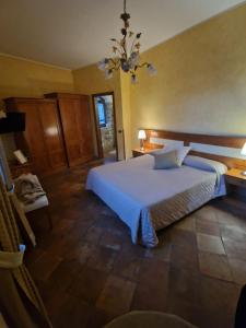 a bedroom with a large bed and a chandelier at Tenuta Oliva in Fisciano