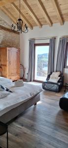 a bedroom with two beds and a large window at Agriturismo La Pina in Tarzo