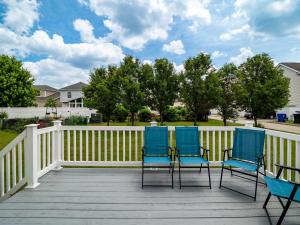 three blue chairs on a deck with a fence at Steps to CLE Clinic - Great for Families - ADA in Cleveland