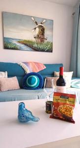 a table with a bottle of wine and a box of food at Apartamento Perla Atalaya in Puerto del Carmen